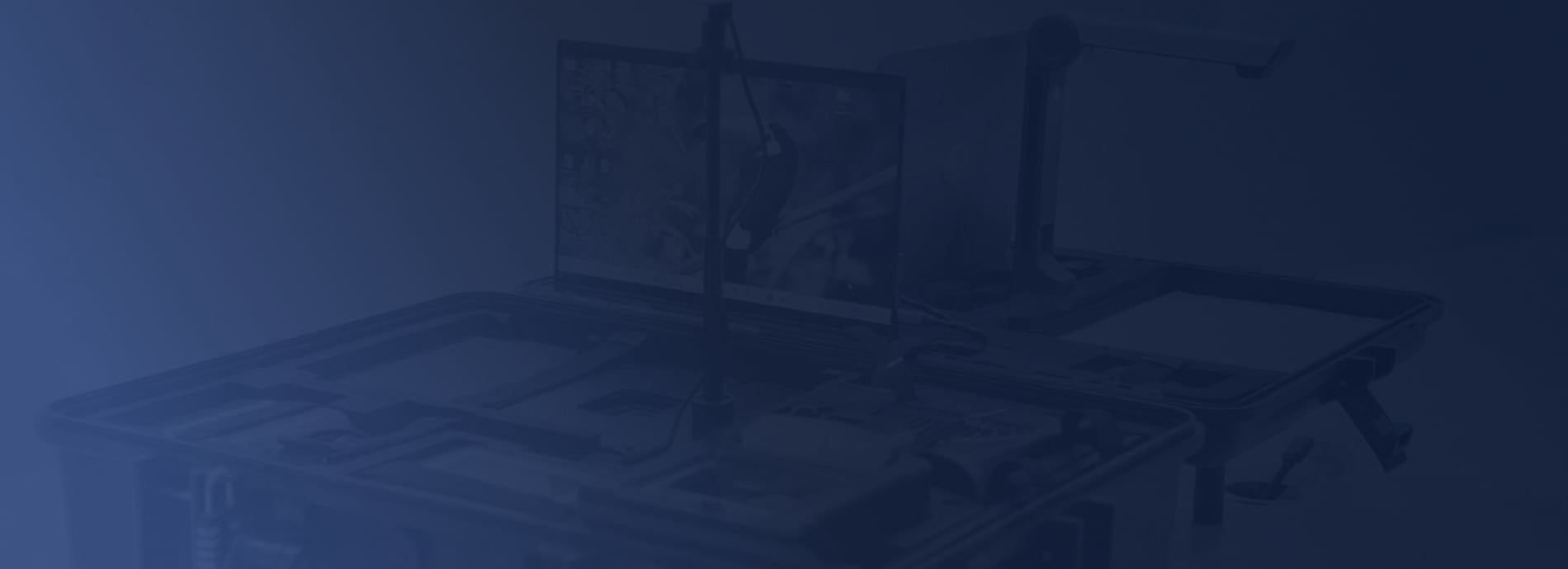 Office desk with a laptop, desktop computer displaying charts  Mantra Softech about us hero